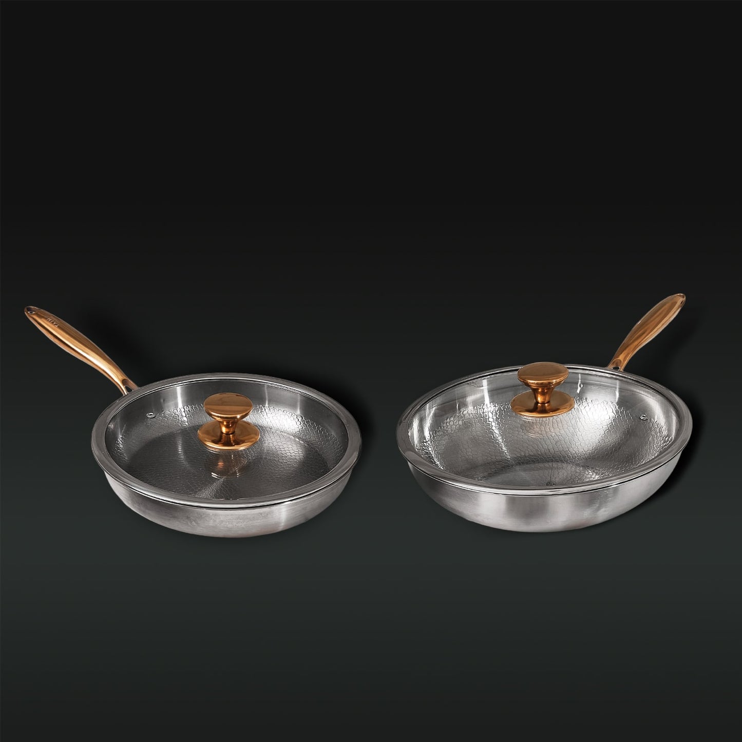 Two Titanium frying pans with gold handles and lids