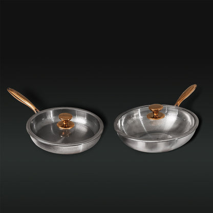 Two Titanium frying pans with gold handles and lids