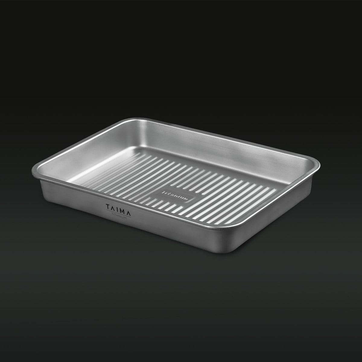 Titanium baking tray with 'Taima' branding on a black background