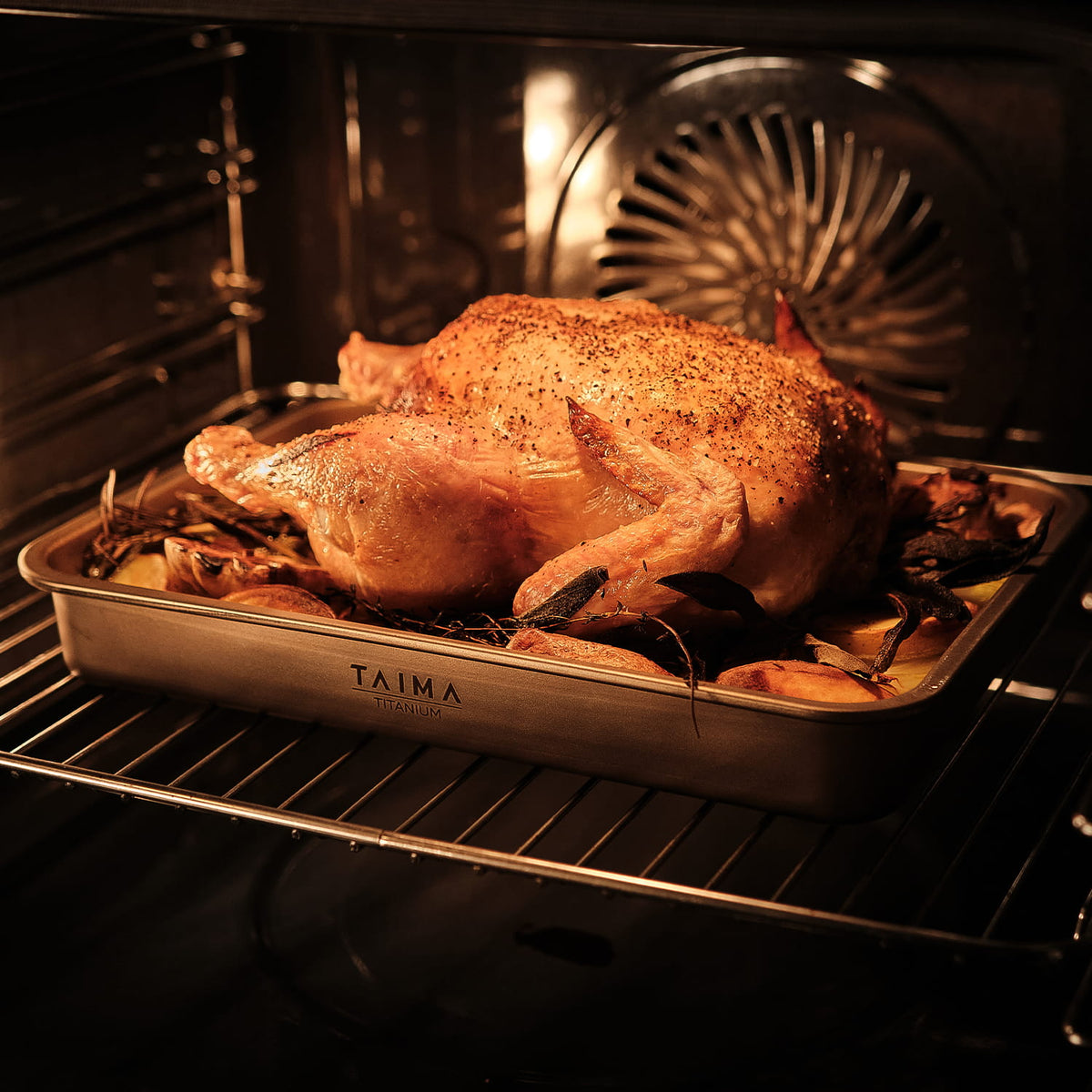 Roasted chicken in an oven with a Taima titanium tray