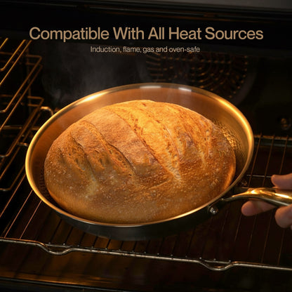Baked loaf of bread in a Titanium pan inside an oven with text 'Compatible With All Heat Sources'.